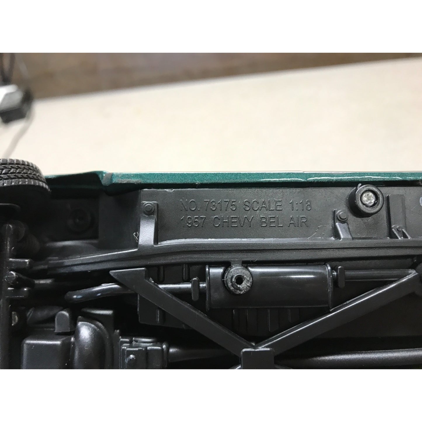 Close-up of a model car chassis with branding and specifications.