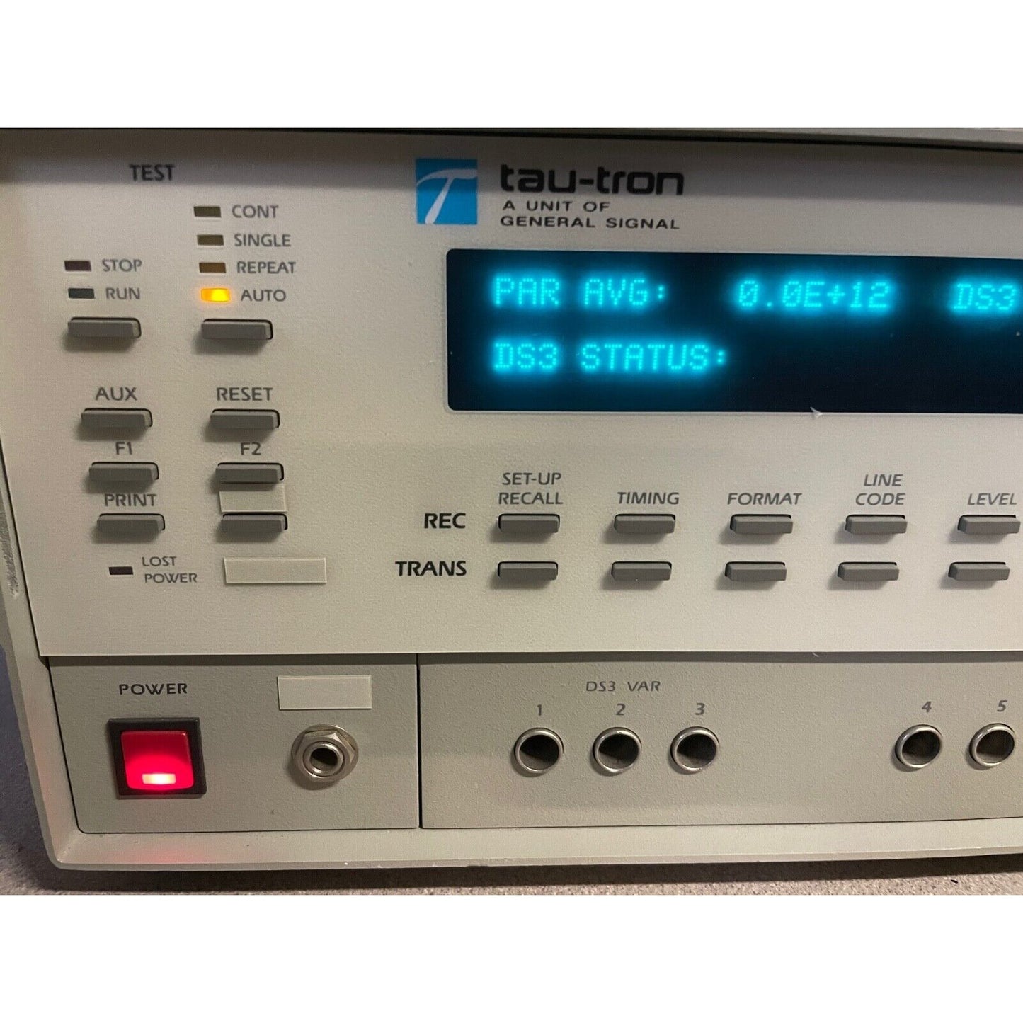 Tau-tron Model 5300 closeup of left side of front panel turned on with display