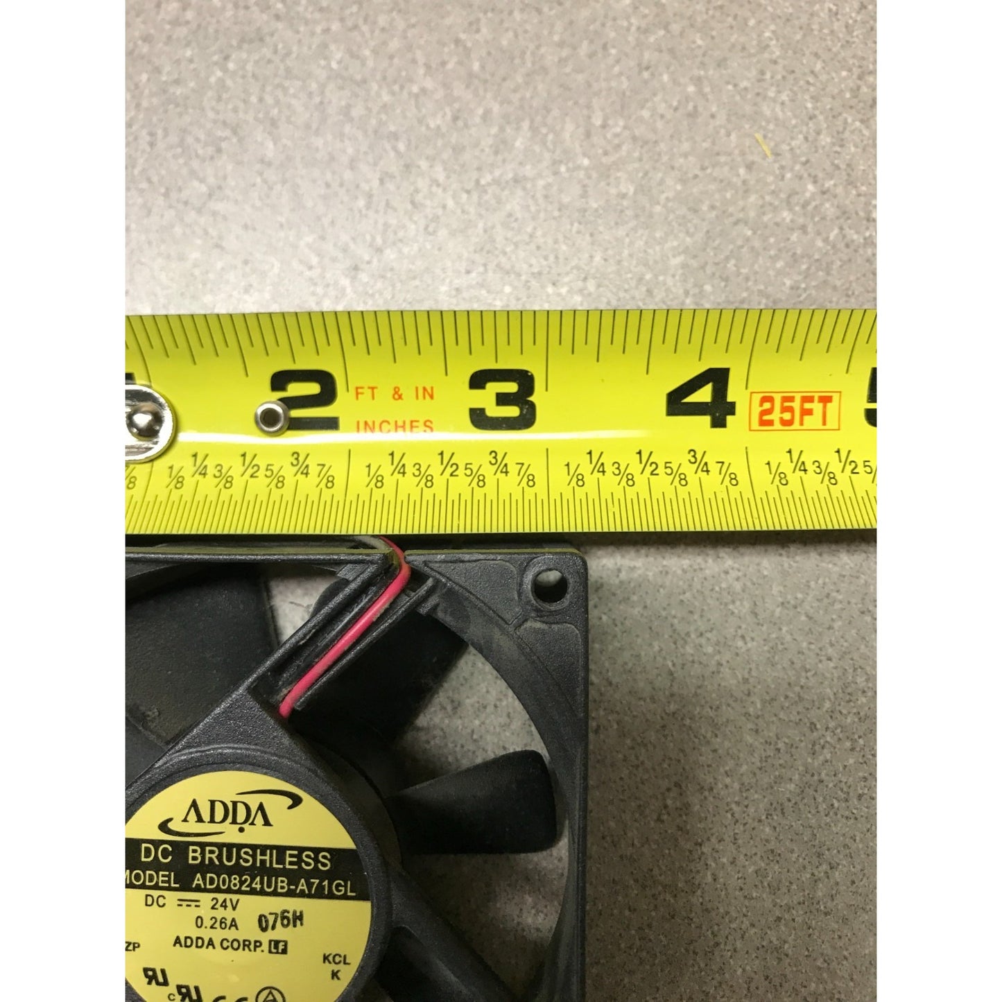 DC Brushless 2 Wire Fan ADDA AD0824UB-A71GL 12VDC closeup of tape measuring 3 1/8 in