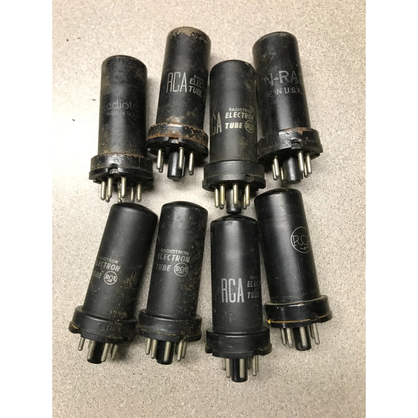 Lot of 8 - 6V6 Vacuum Tubes (7 RCA Radiotron and one KEN-RAD) overhead view of 8 vacuum tubes
