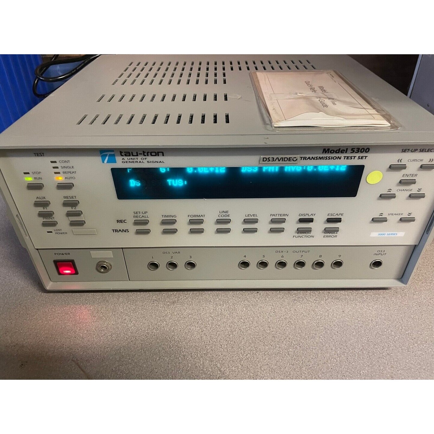 Tau-tron Model 5300 front panel powered on with screen display on