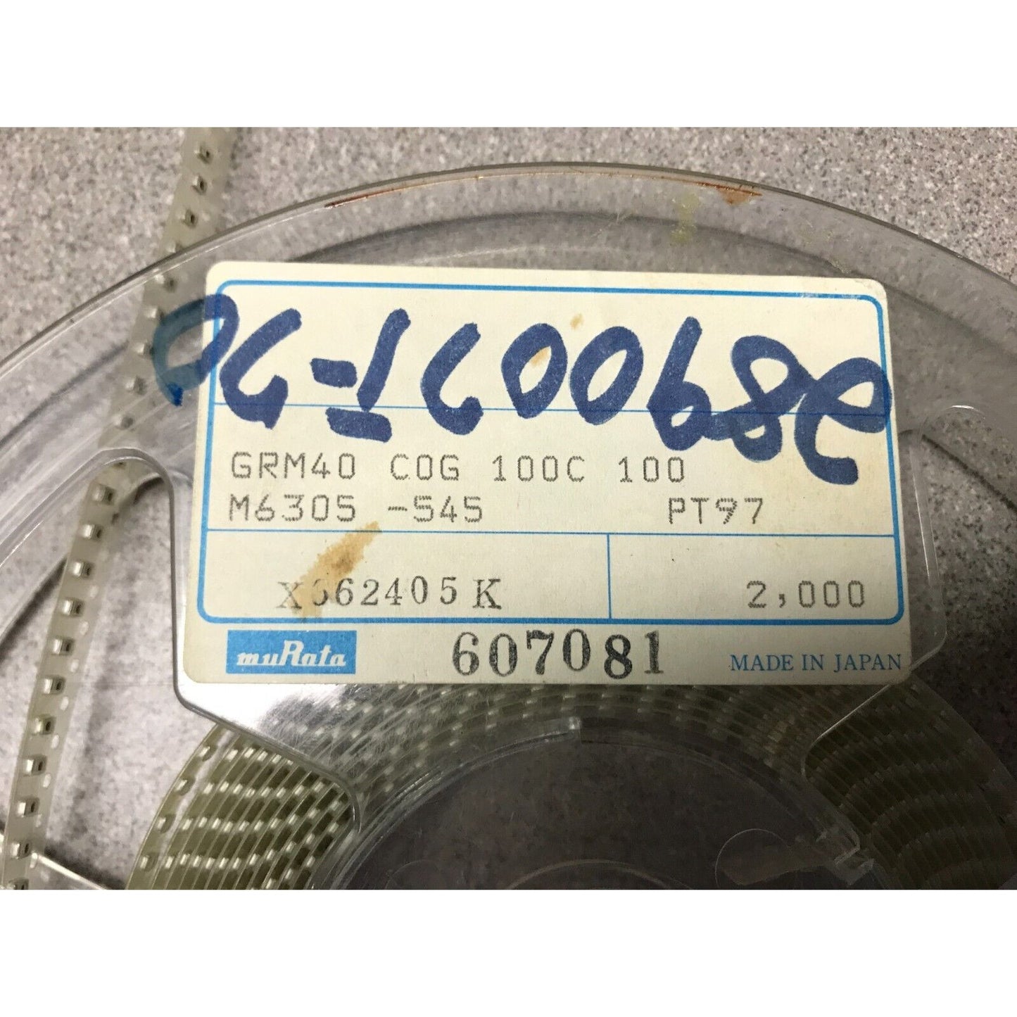 Murata SMD Chip Resistor Stripe GRM40 COG 100C 100 M6305-545 PT97 closeup of product label on reel