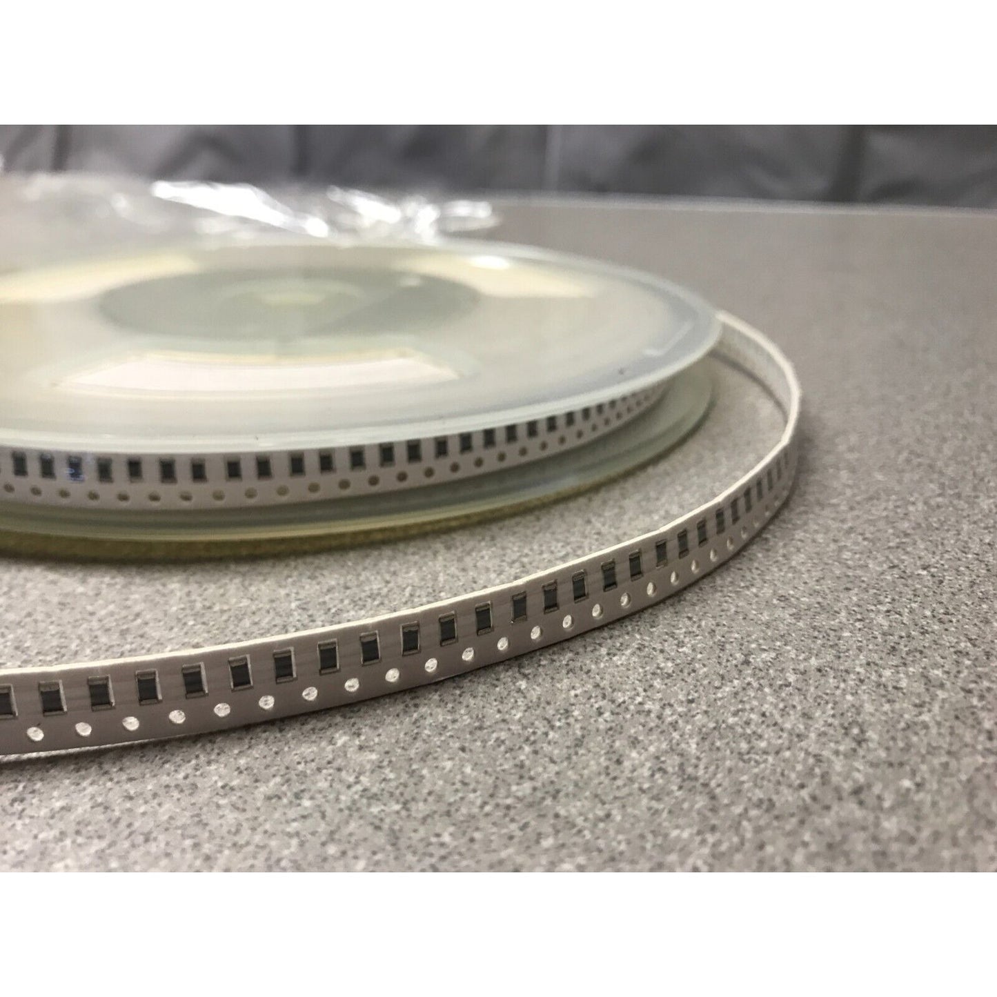Murata SMD Chip Resistor Stripe RX 3911 G100J-TA closeup of reel