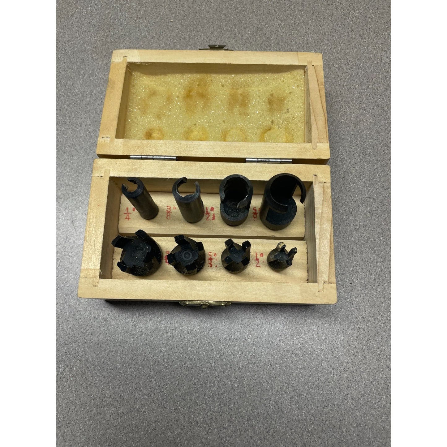 8 Piece Wood Plug Cutter Set 1/4" - 1/2" In Wooden Case top view of cutters with size labeled in wooden case