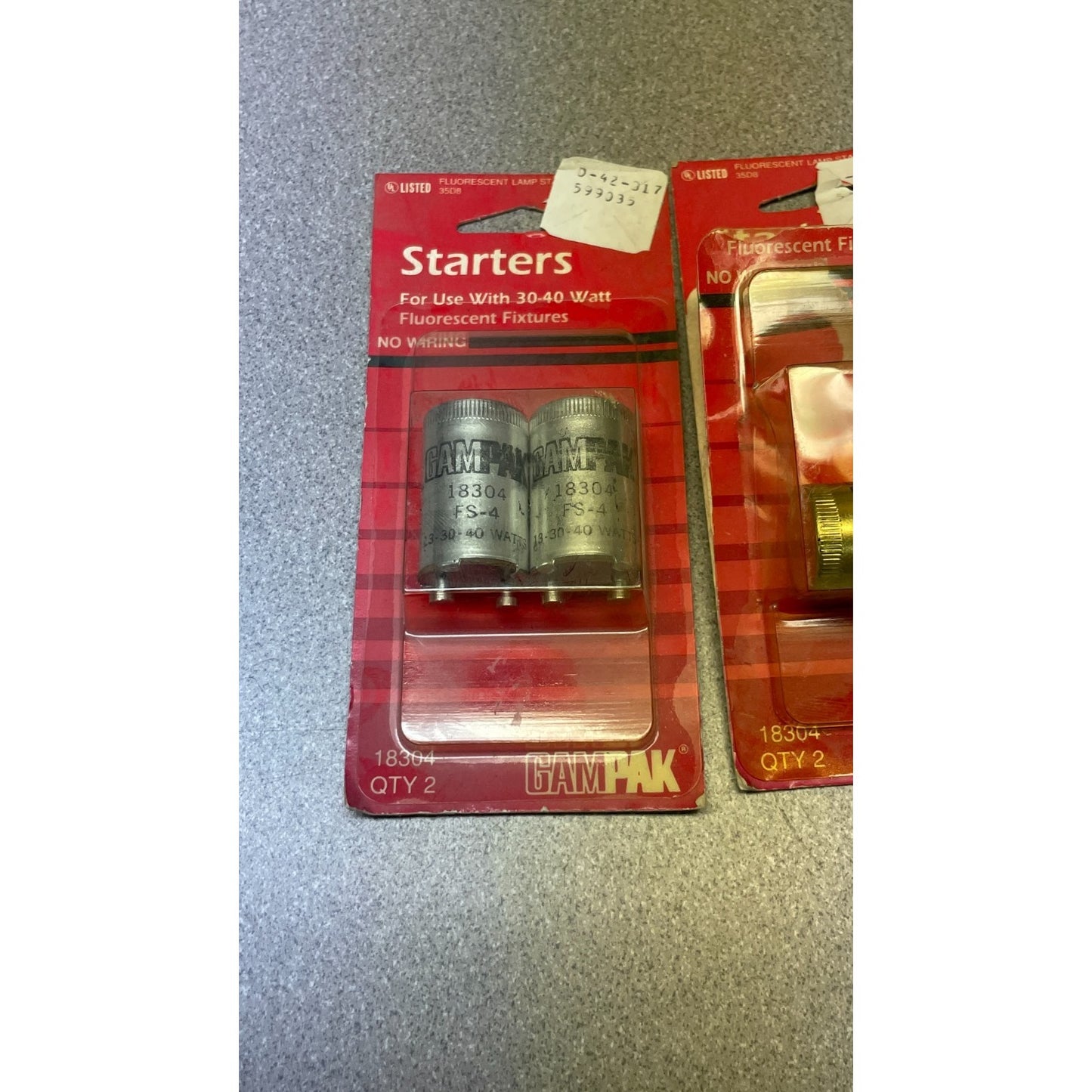 Packaged Gampak starters for fluorescent fixtures on a metallic surface