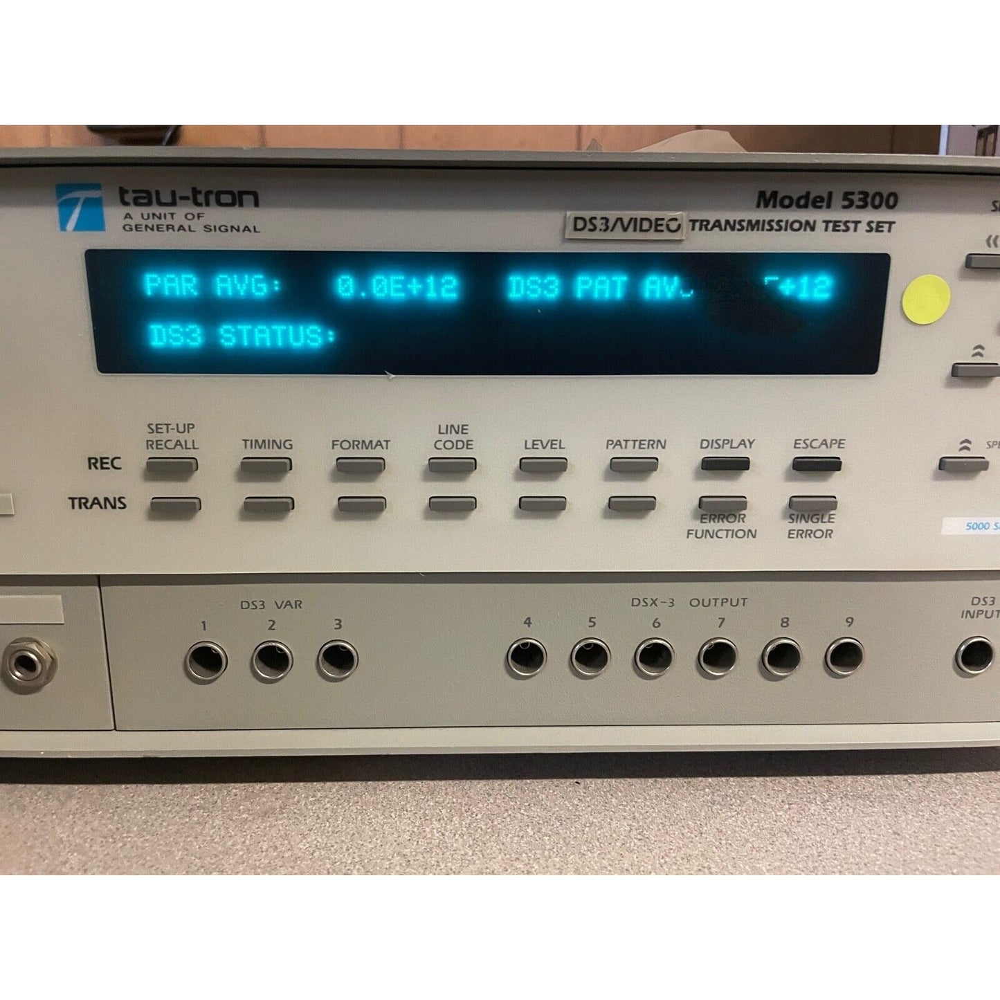 A Tau-tron Model 5300 video transmission test set with a digital display and various control buttons and ports.
