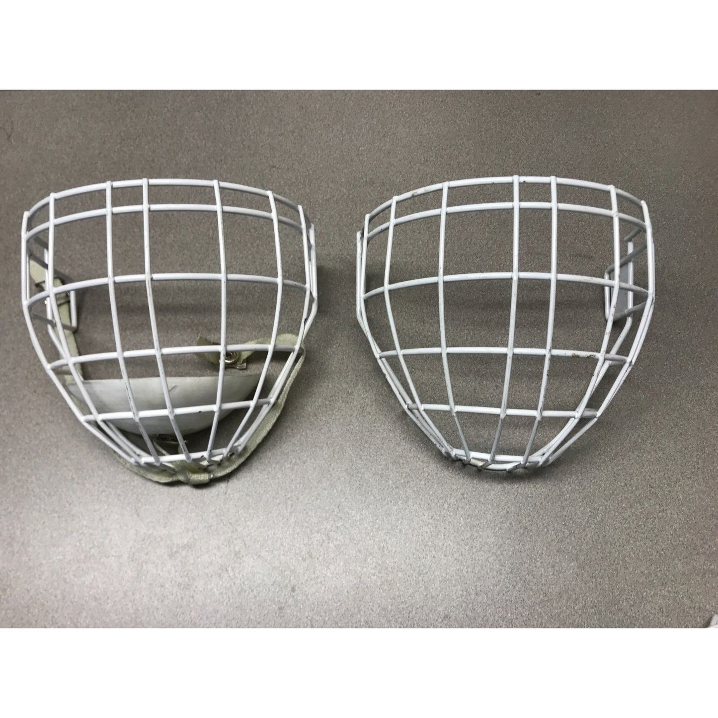 Two Hockey Cage Masks White Metal 7.5 inch (one with chin pad) front view