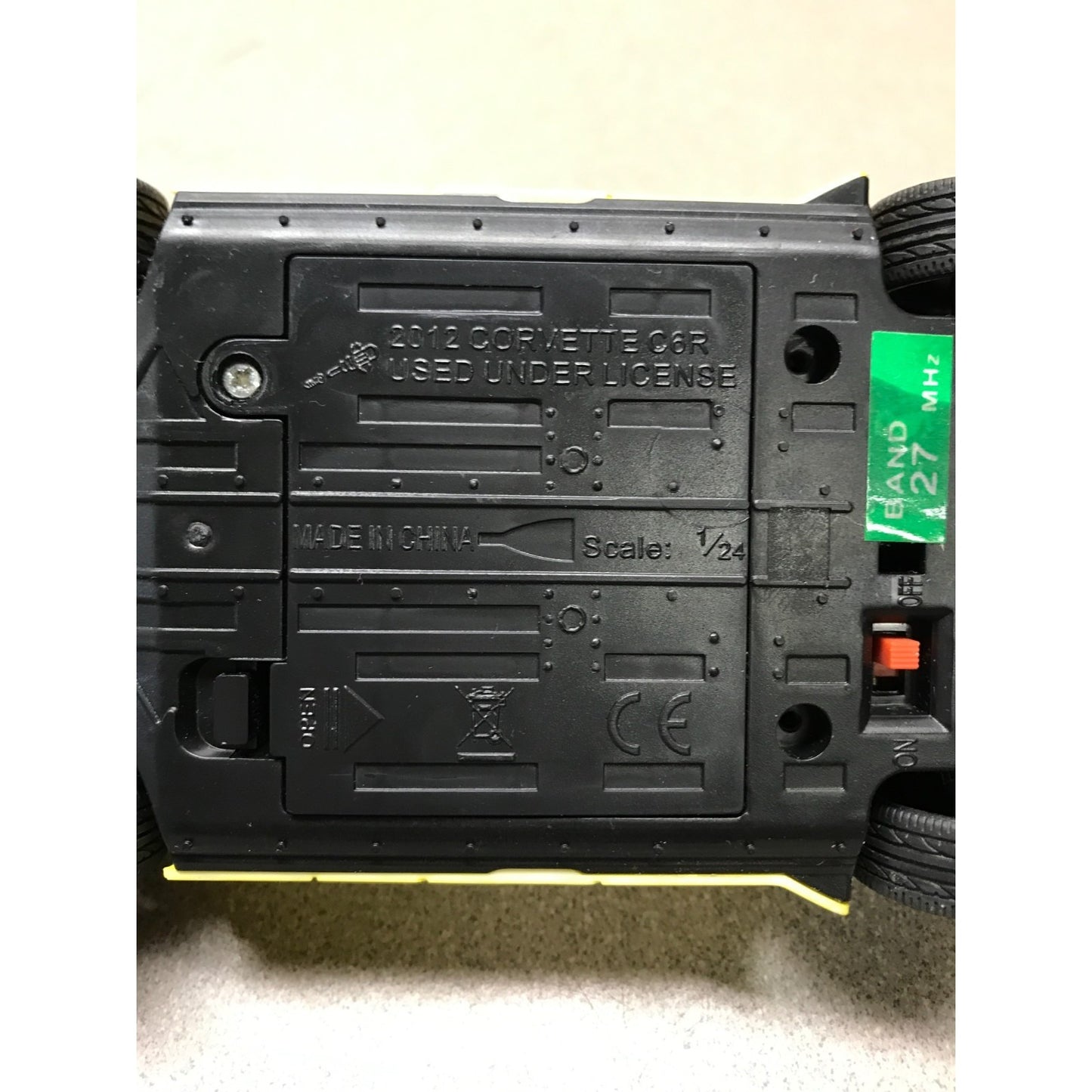 Back view of a toy car with branding and technical details on a light background