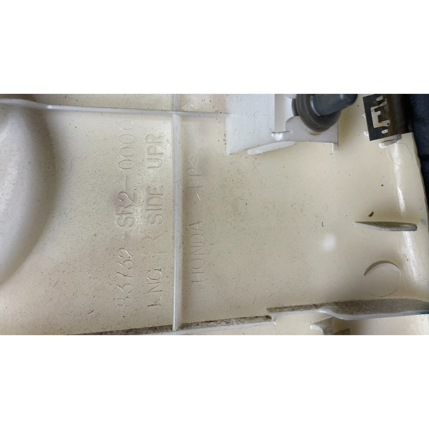 OEM Honda Civic Del Sol Right Upper Rear Speaker Cover 83782-SR2-0000 closeup of manufacture product stamp