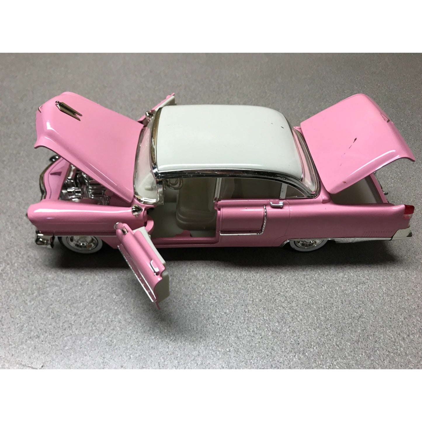 1955 Cadillac Fleetwood Elvis Presley Pink with Elvis Figurine - Jada Die Cast 1:24 Scale drivers side view with hood doors and trunk open