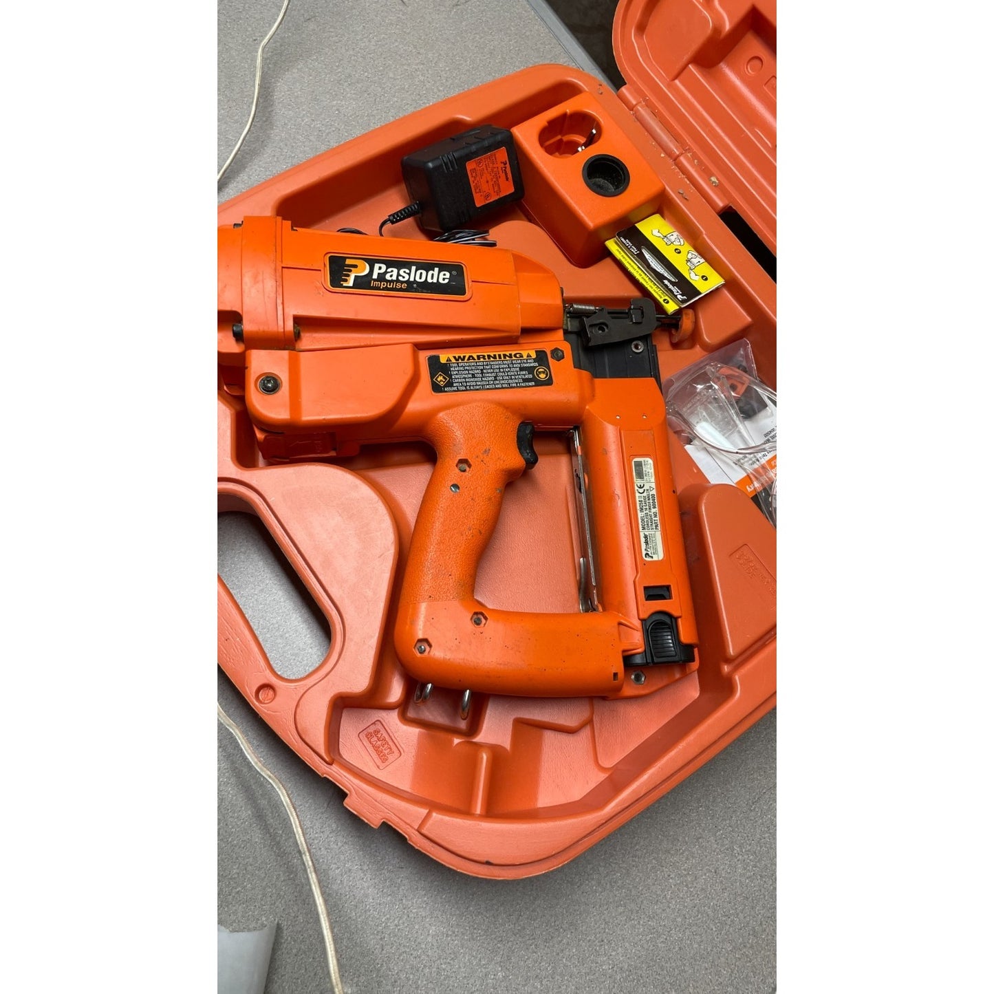 Paslode Impulse IM250 II Cordless 16 gauge Straight Finish Nailer 900400, Untested, Includes Case and Accessories view of nail gun in case with accessories