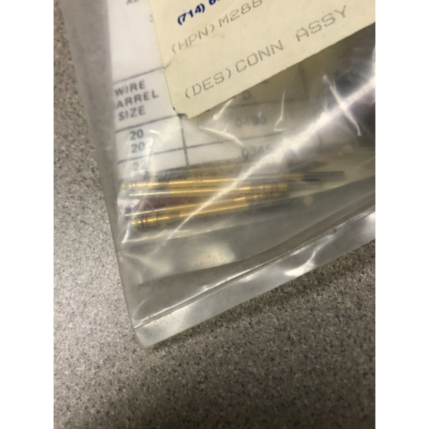 Hughes Circular Connector Assembly M28840/14AA1S1 gold cylinders closeup in package