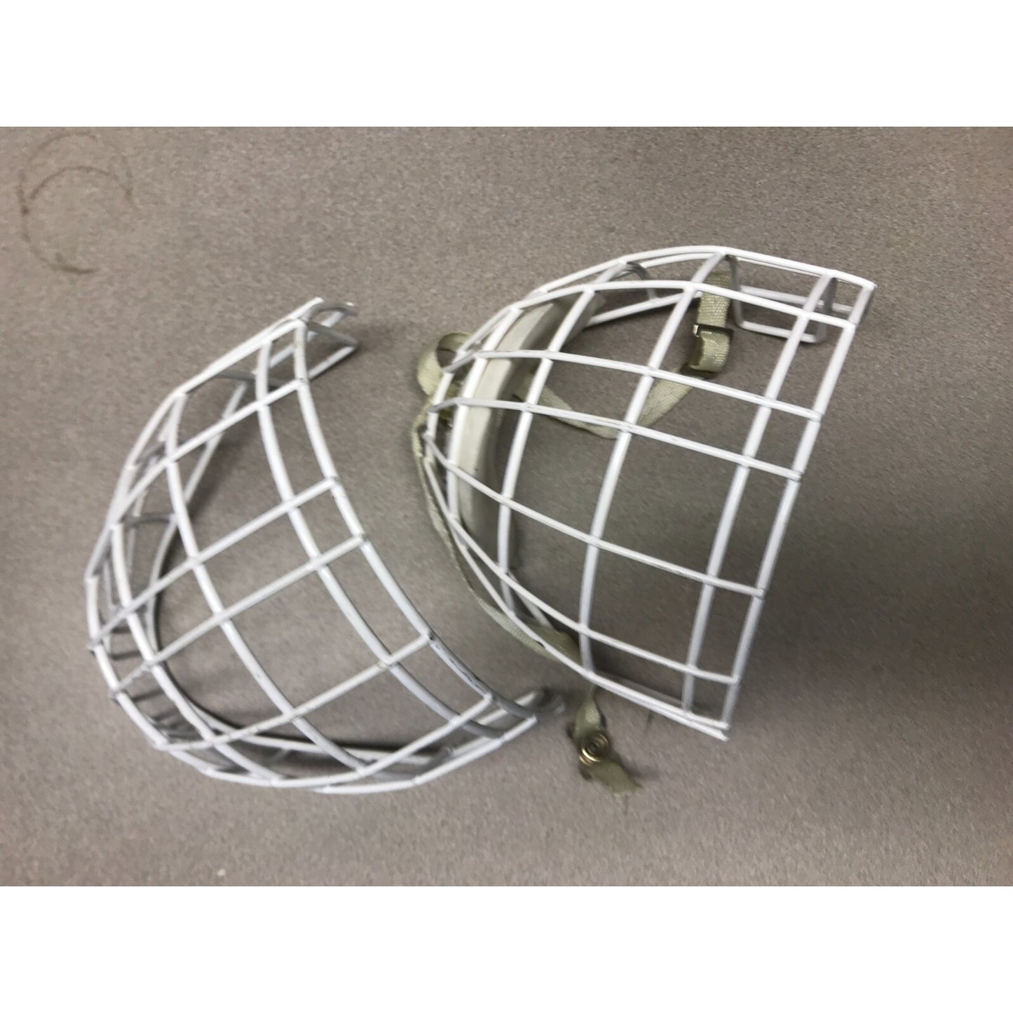 Two Hockey Cage Masks White Metal 7.5 inch (one with chin pad) front view