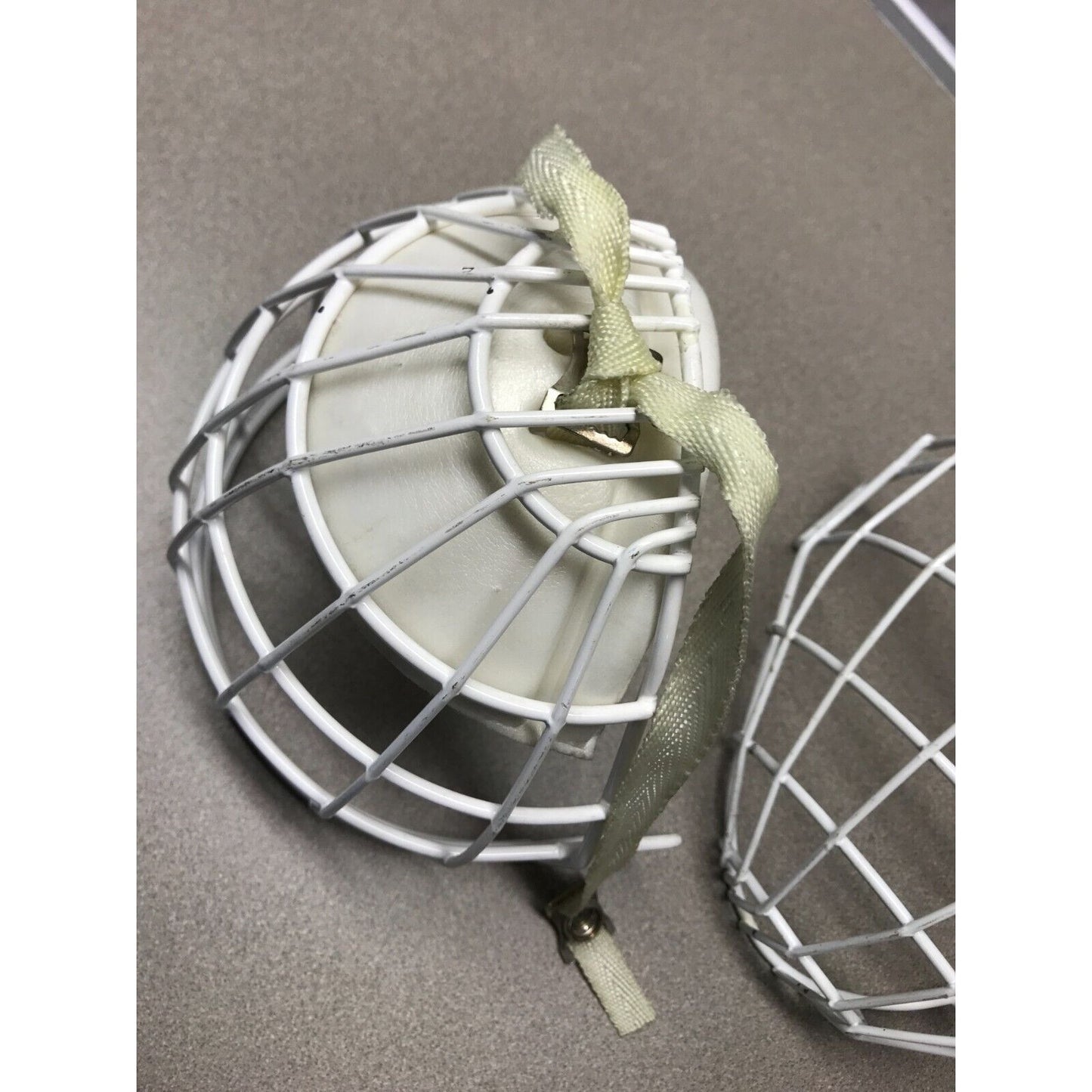 Two Hockey Cage Masks White Metal 7.5 inch (one with chin pad) bottom view with chin pad
