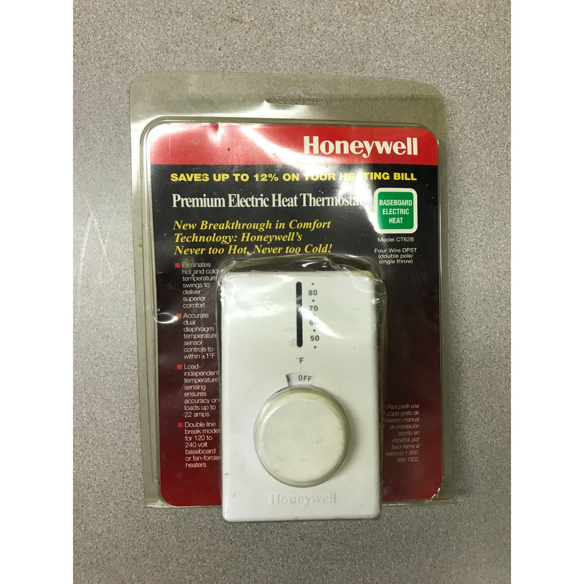 Honeywell Premium Electric Heat Thermostat in its original blister packaging, featuring a white plastic dial thermostat with a red and black backing card.