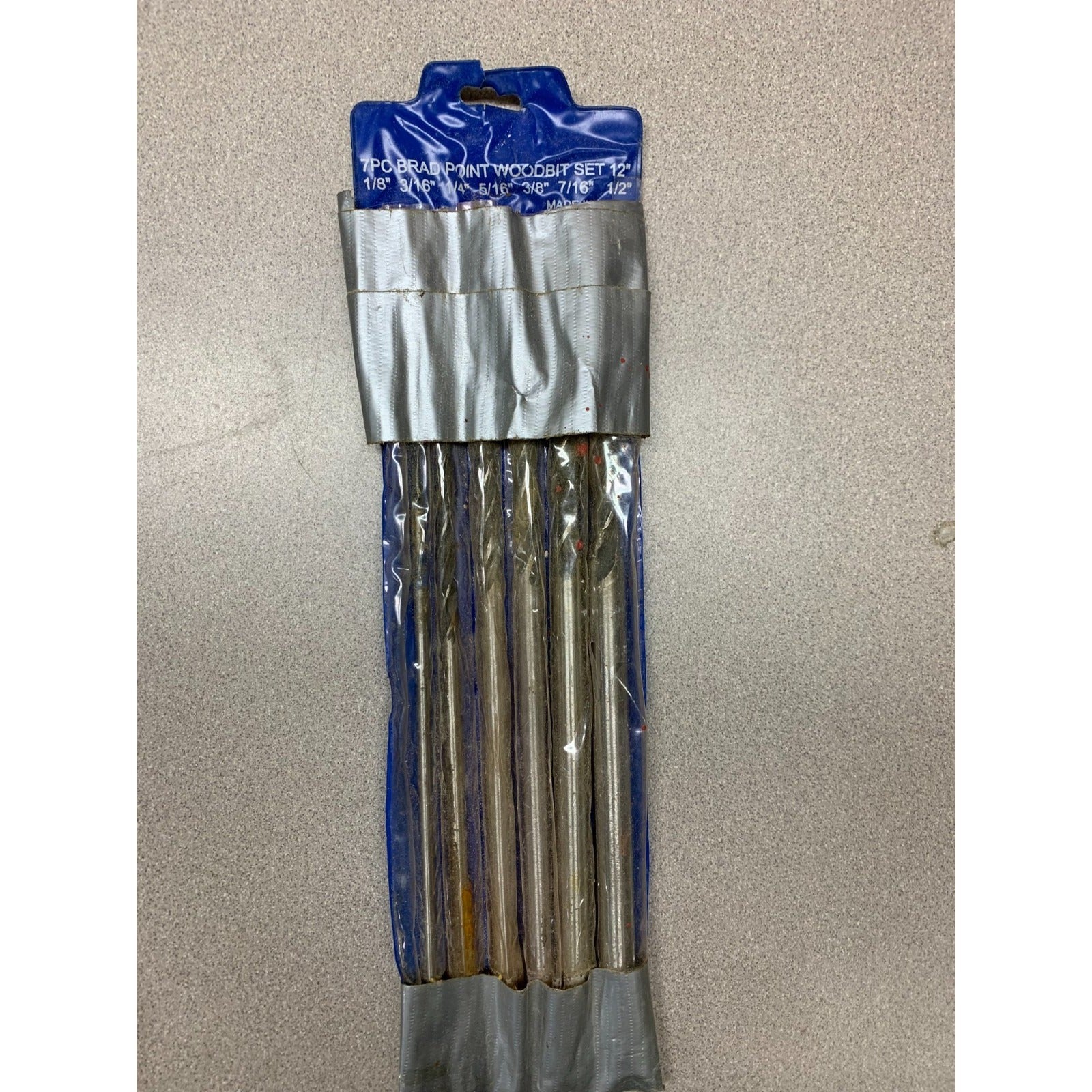 7pc 12" Brad Point Wood Bit Set full length view of drill bits in package with duct tape around the top