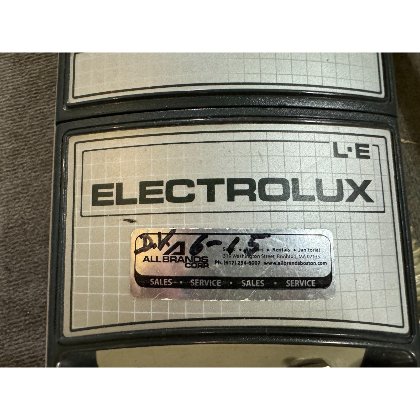Electrolux branded appliance with a service label on a grid background