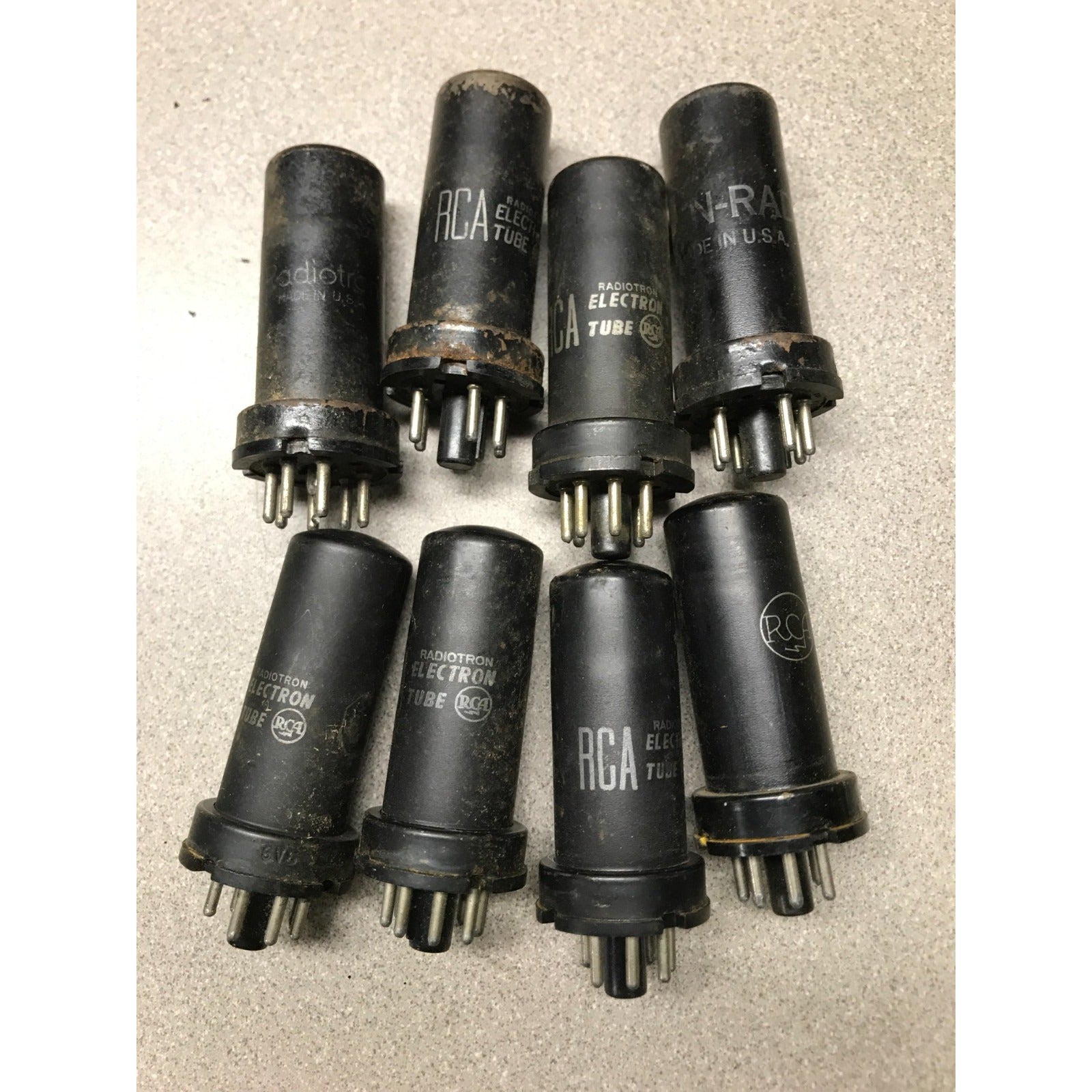 Lot of 8 - 6V6 Vacuum Tubes (7 RCA Radiotron and one KEN-RAD) overhead view of 8 vacuum tubes