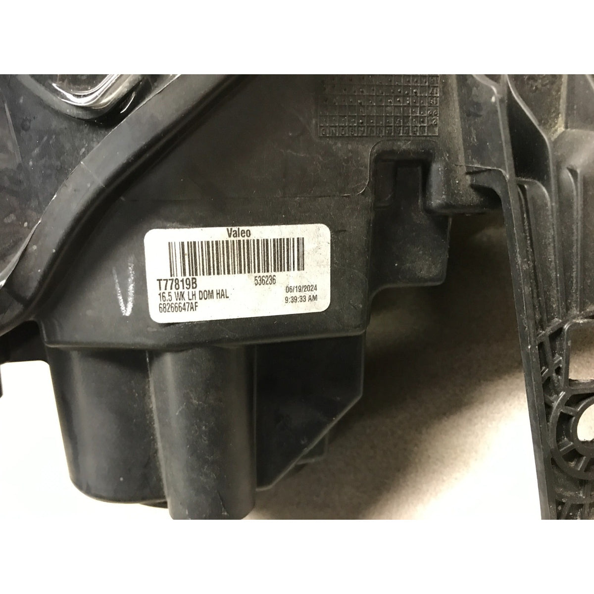 2019 Jeep Grand Cherokee Altitude Front Left LH Drivers Side OEM Headlight Lens closeup of product label