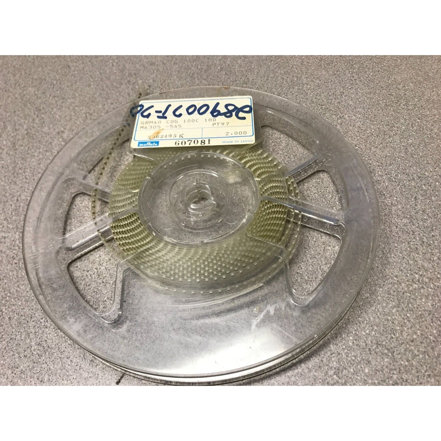 Murata SMD Chip Resistor Stripe GRM40 COG 100C 100 M6305-545 PT97 top view of reel with product label