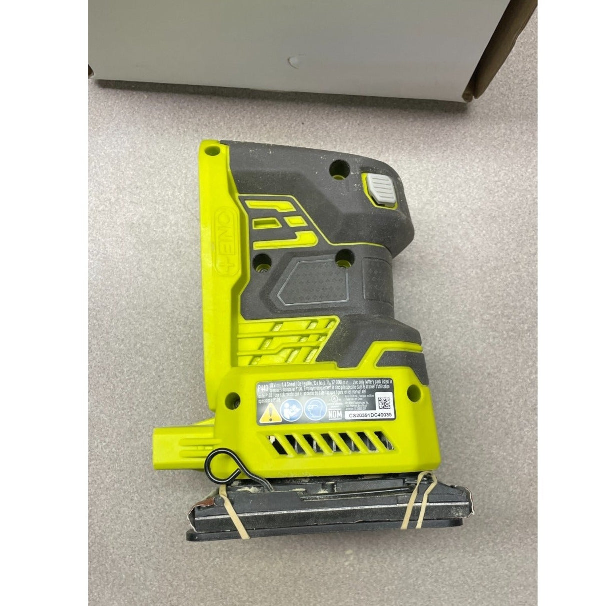 Ryobi P440 ONE+ 18v 1/4 Sheet Sander side view of sander with product label