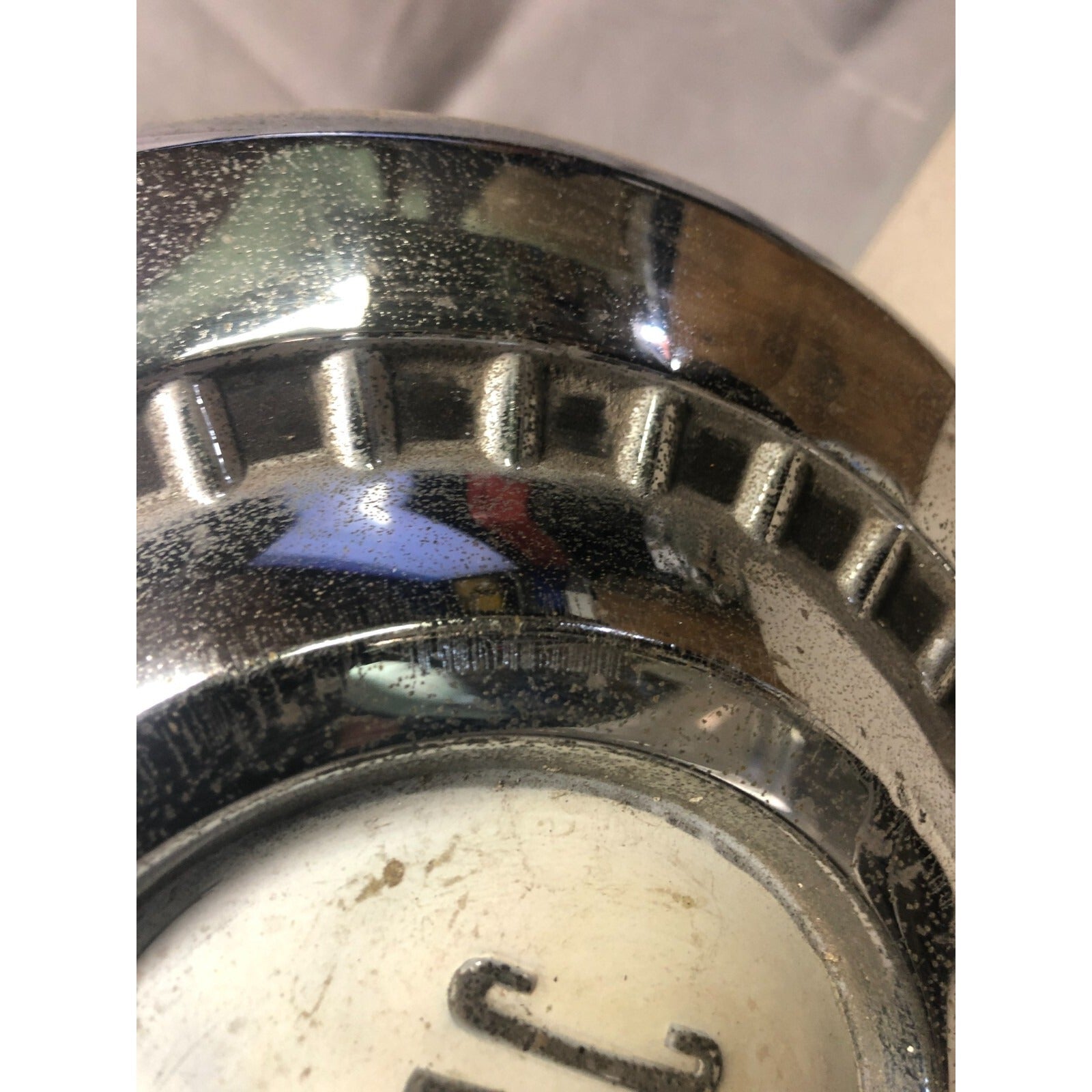 1966 Pontiac Chrome OEM Wheel Center Cap close up of chrome