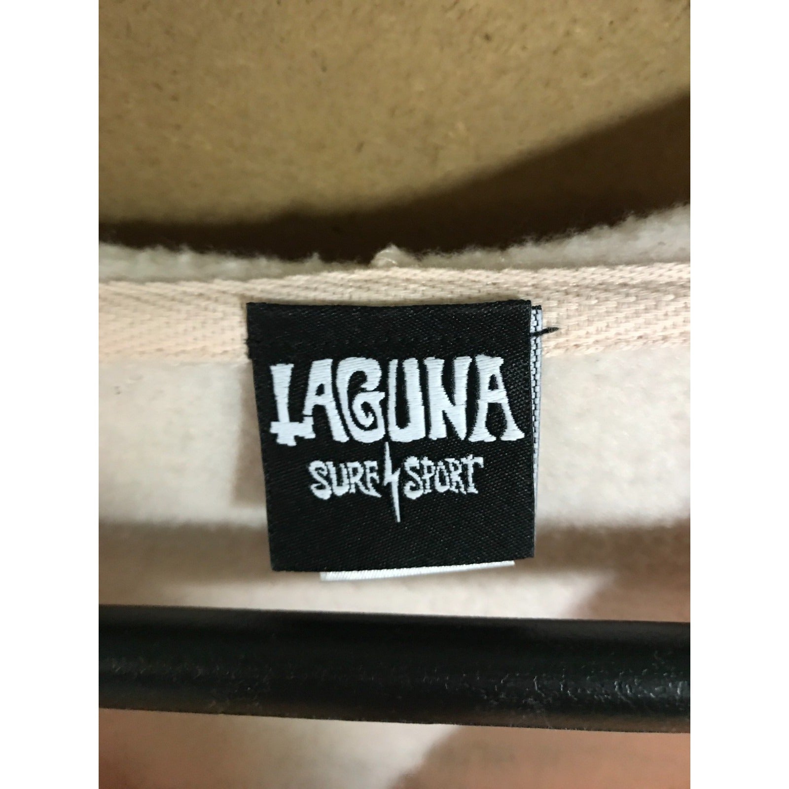 Laguna Surf Sport label on a product with a beige background
