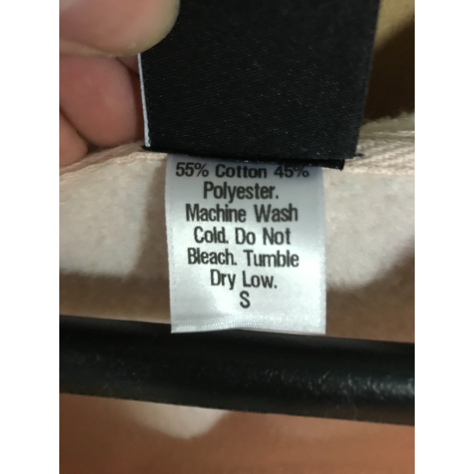 Clothing label with fabric composition and care instructions on a garment.