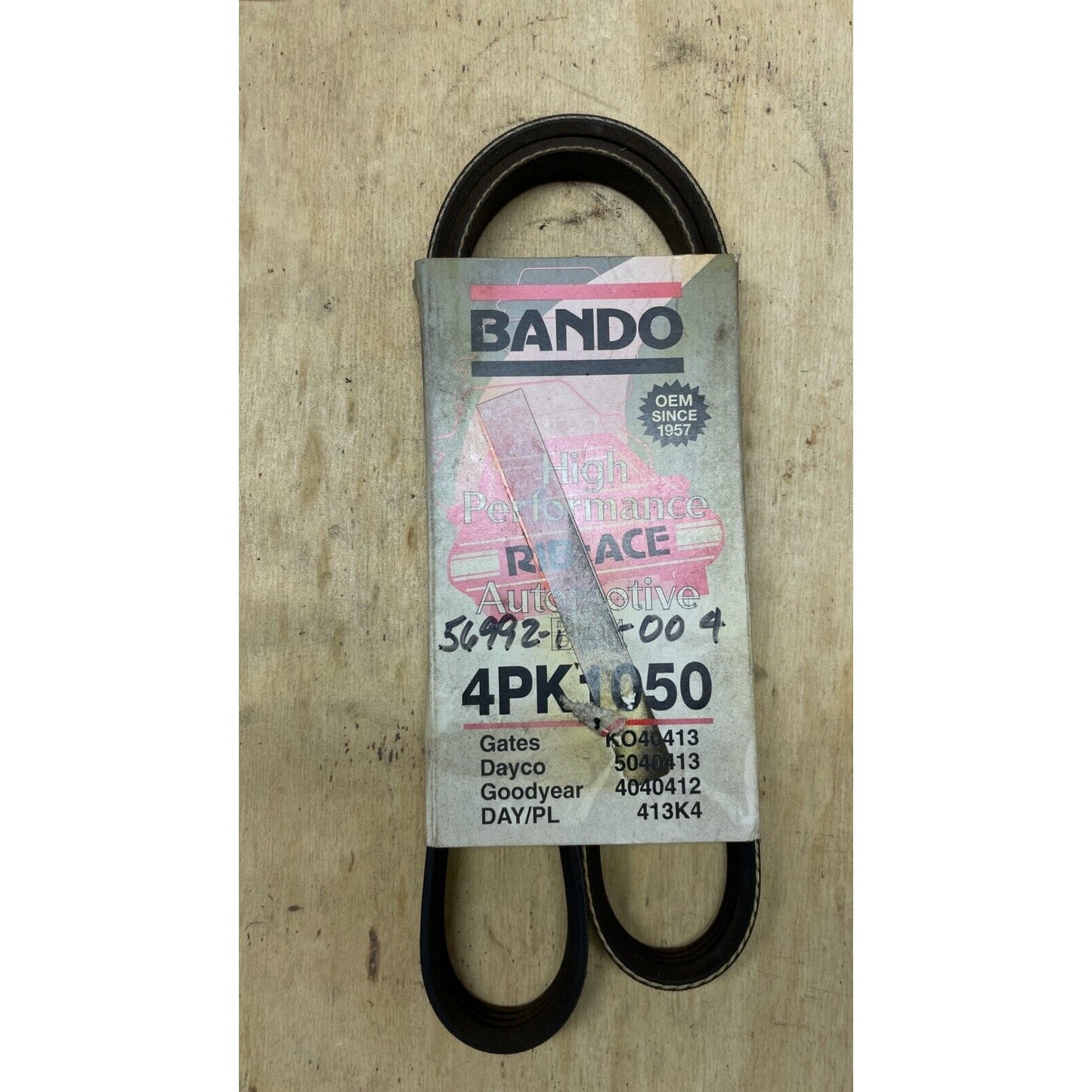 Bando belt packaging on a wooden surface