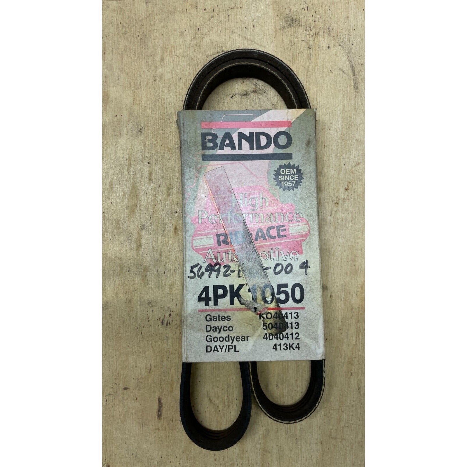 Bando belt packaging on a wooden surface