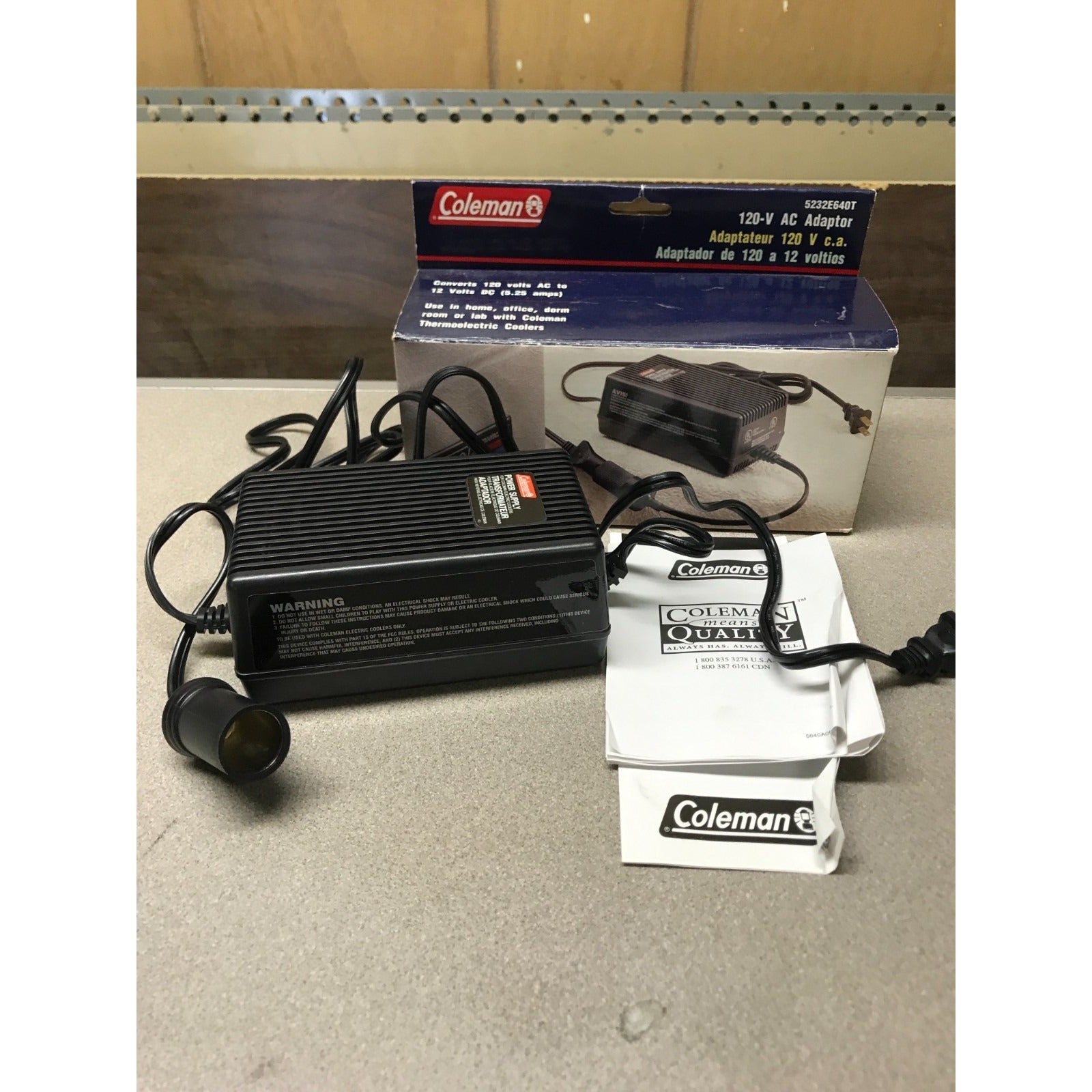 Coleman 120-V AC Adaptor, Converts to 12 Volts DC (5.25 amps), 5232E640T adaptor and user manual in front of box