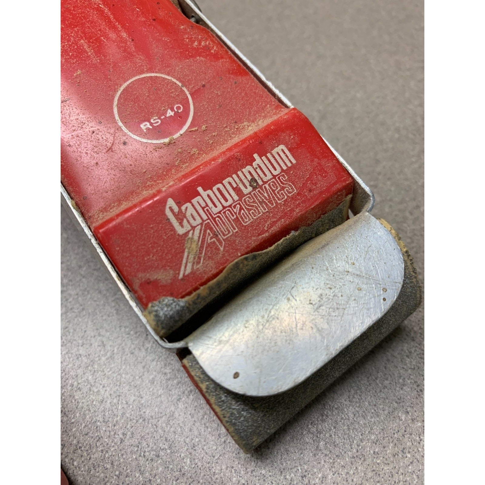 Carborundum sanding block closeup of logo