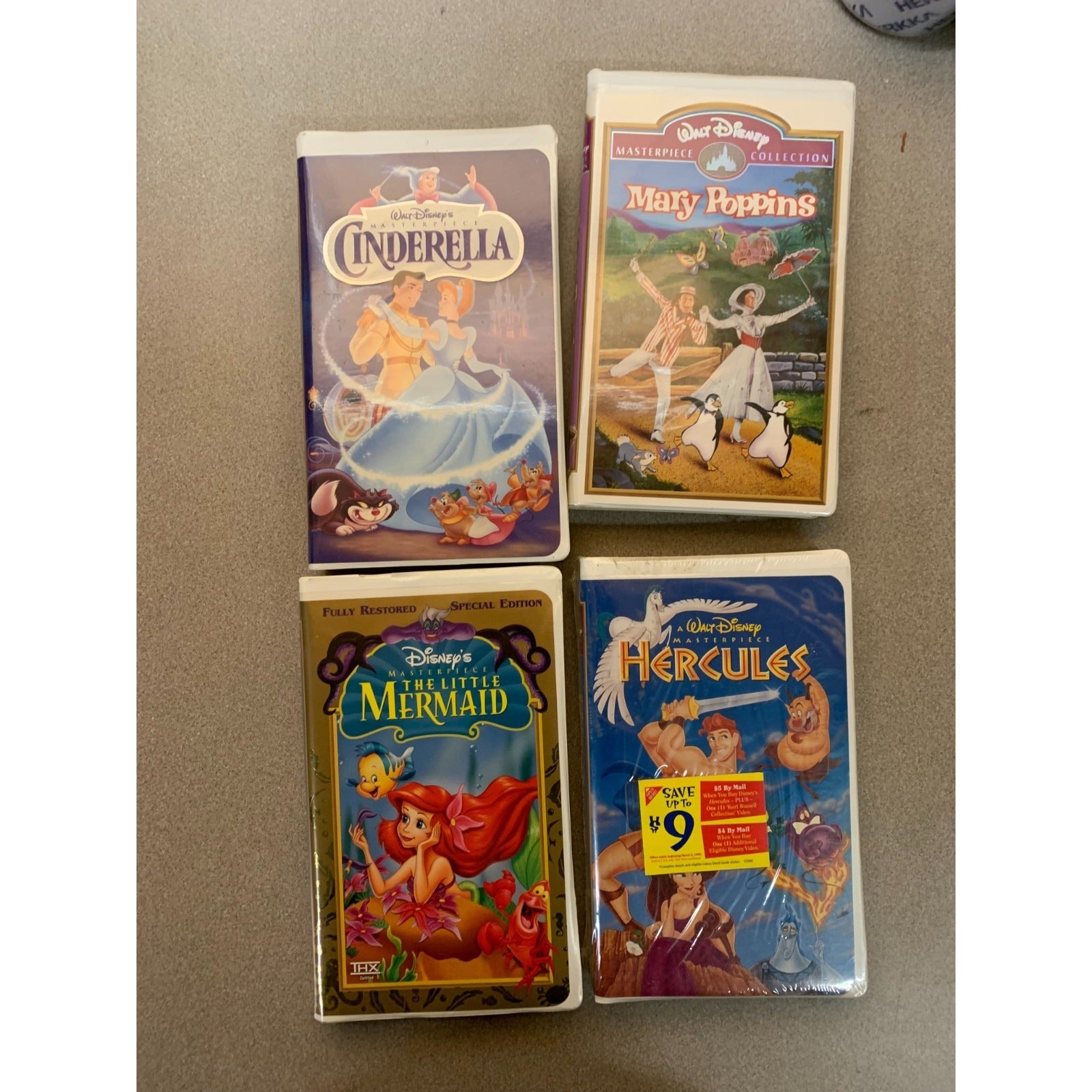 Disney VHS Masterpiece Collection set of 4 - Hercules (sealed!), Mary Poppins, Cinderella, and The Little Mermaid front of 4 video cases