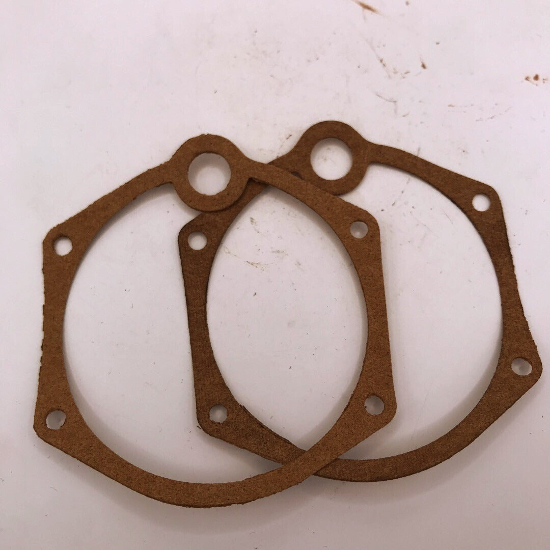Two brown gaskets on a white background