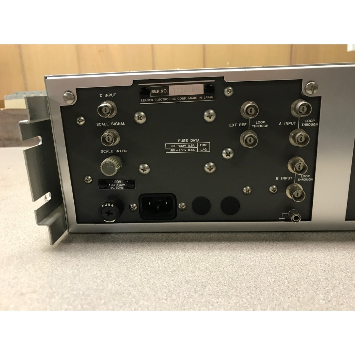 The rear panel of a Leeder Electronics LEADER-1000 electronic signal generator, showing various input/output connectors, knobs, and a power input socket on a silver chassis.
