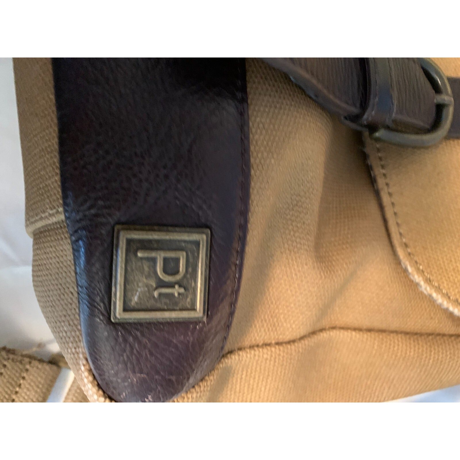 Brown/Tan Satchell Laptop Bag PT closeup of Pt logo
