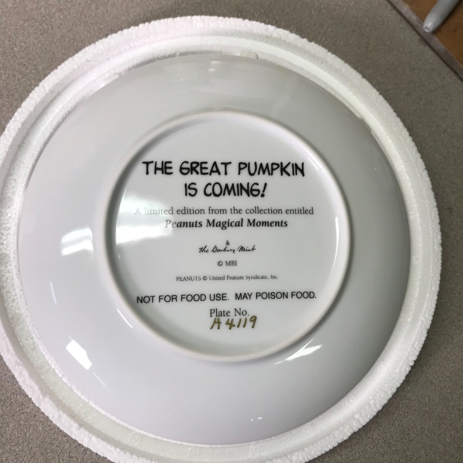 The Danbury Mint Peanuts Magical Moments Plates "The Great Pumpkin is Coming!,"  back of plate with title and serial number