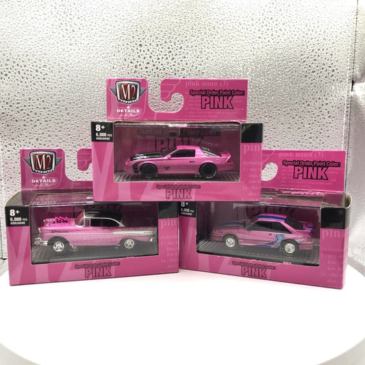 M2 Pink Cars Set of 3 - Includes 1985 Chevrolet Camaro IROC-Z, 1957 Chevrolet Bel Air Gasser, and 1987 Ford Mustang GT - Custom front view in package displaying cars