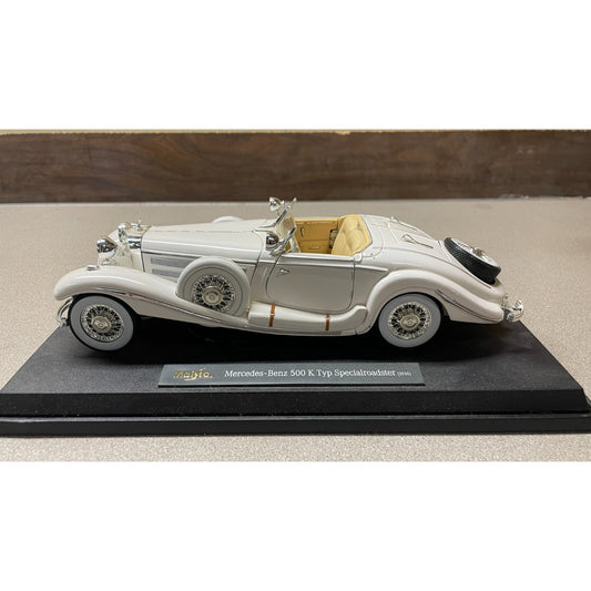 Maisto White 1936 Mercedes-Benz 500 K Typ Specialroadster 1:18 Scale Diecast Model drivers side view on display stand