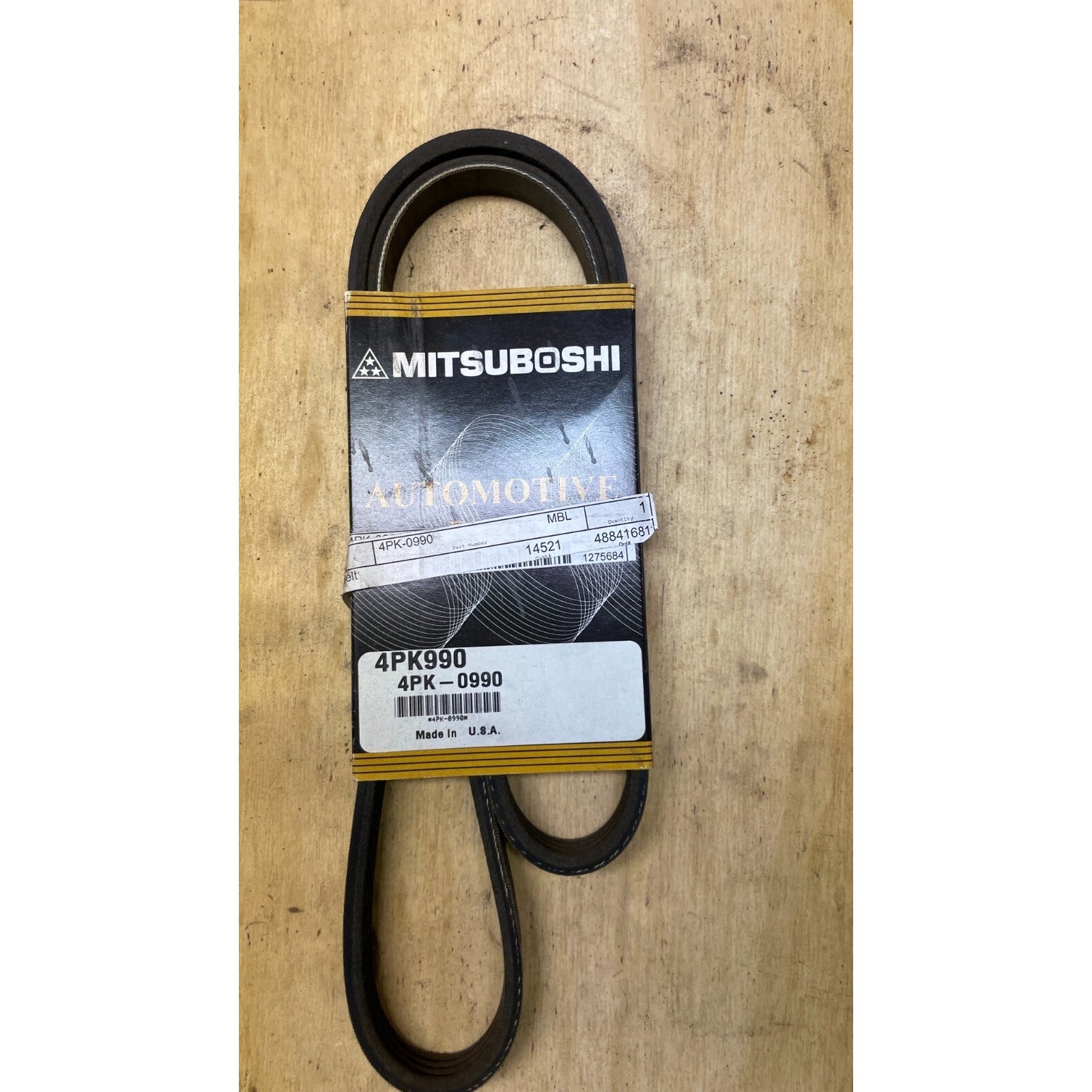 Mitsuboshi 4PK990 Automotive Belt front view of belt in packaging