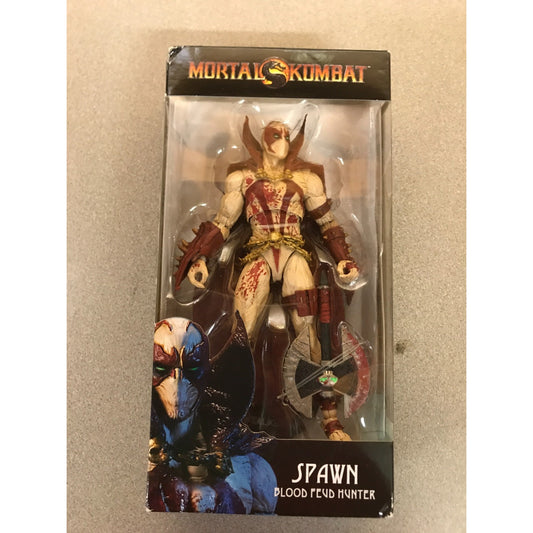 Mortal Kombat Spawn Blood Feud Hunter action figure in its original window box packaging, featuring Spawn with a bow and axe on a beige background.