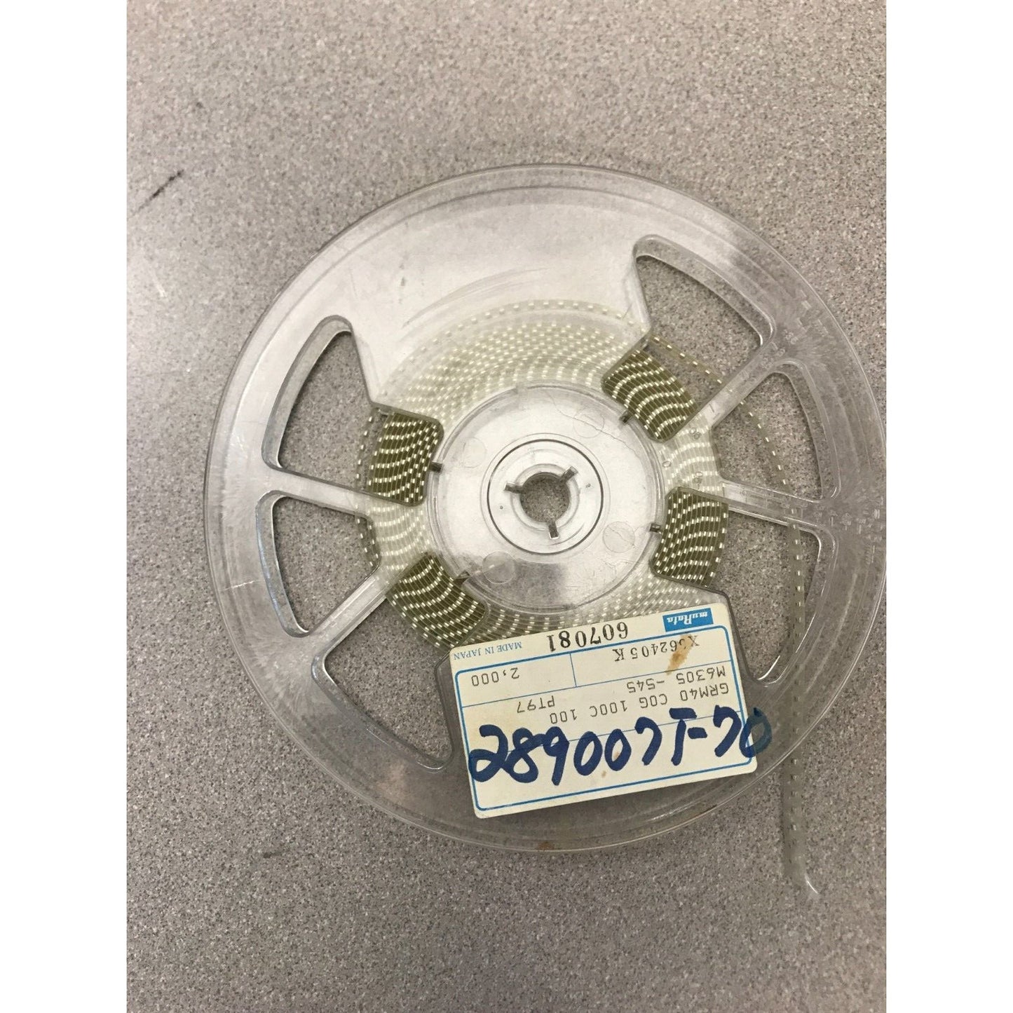 Murata SMD Chip Resistor Stripe GRM40 COG 100C 100 M6305-545 PT97 top view of reel with product label