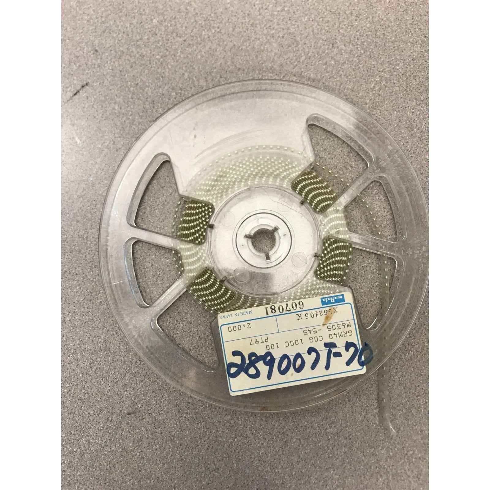 Murata SMD Chip Resistor Stripe GRM40 COG 100C 100 M6305-545 PT97 top view of reel with product label