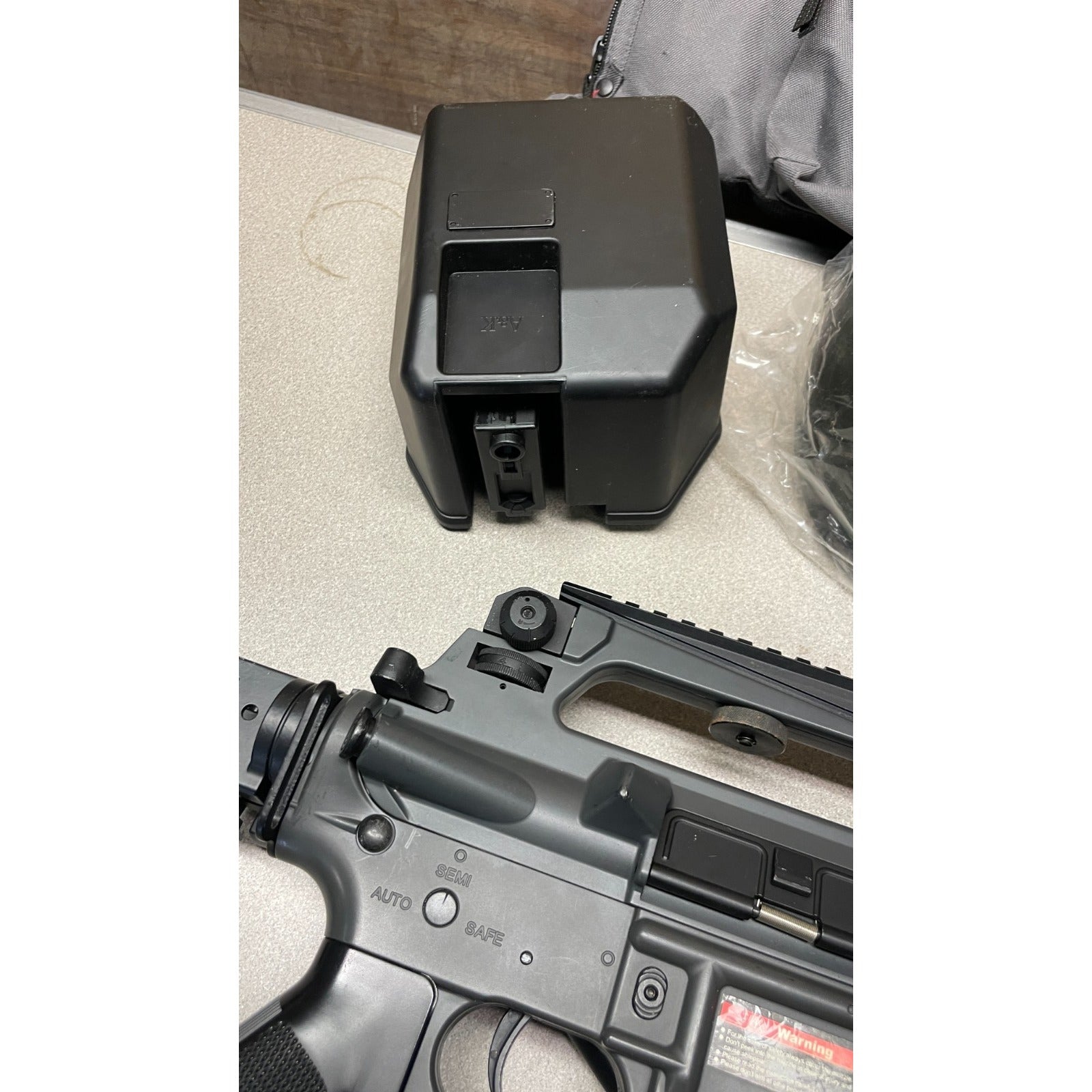 DPMS Panther Arms U050810381 M4 Style Airsoft Gun Lot UNTESTED, Accessories and Bag Included. Swiss Arms Sight, DYE i4 Goggle Lens, Crosman .20 Grams Airsoft closeup of gun settings