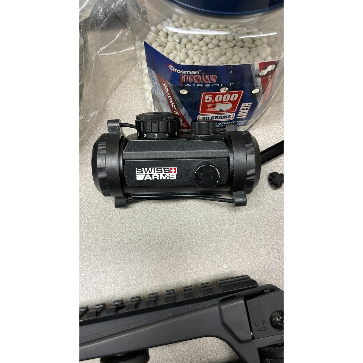 DPMS Panther Arms U050810381 M4 Style Airsoft Gun Lot UNTESTED, Accessories and Bag Included. Swiss Arms Sight, DYE i4 Goggle Lens, Crosman .20 Grams Airsoft closeup of acessories