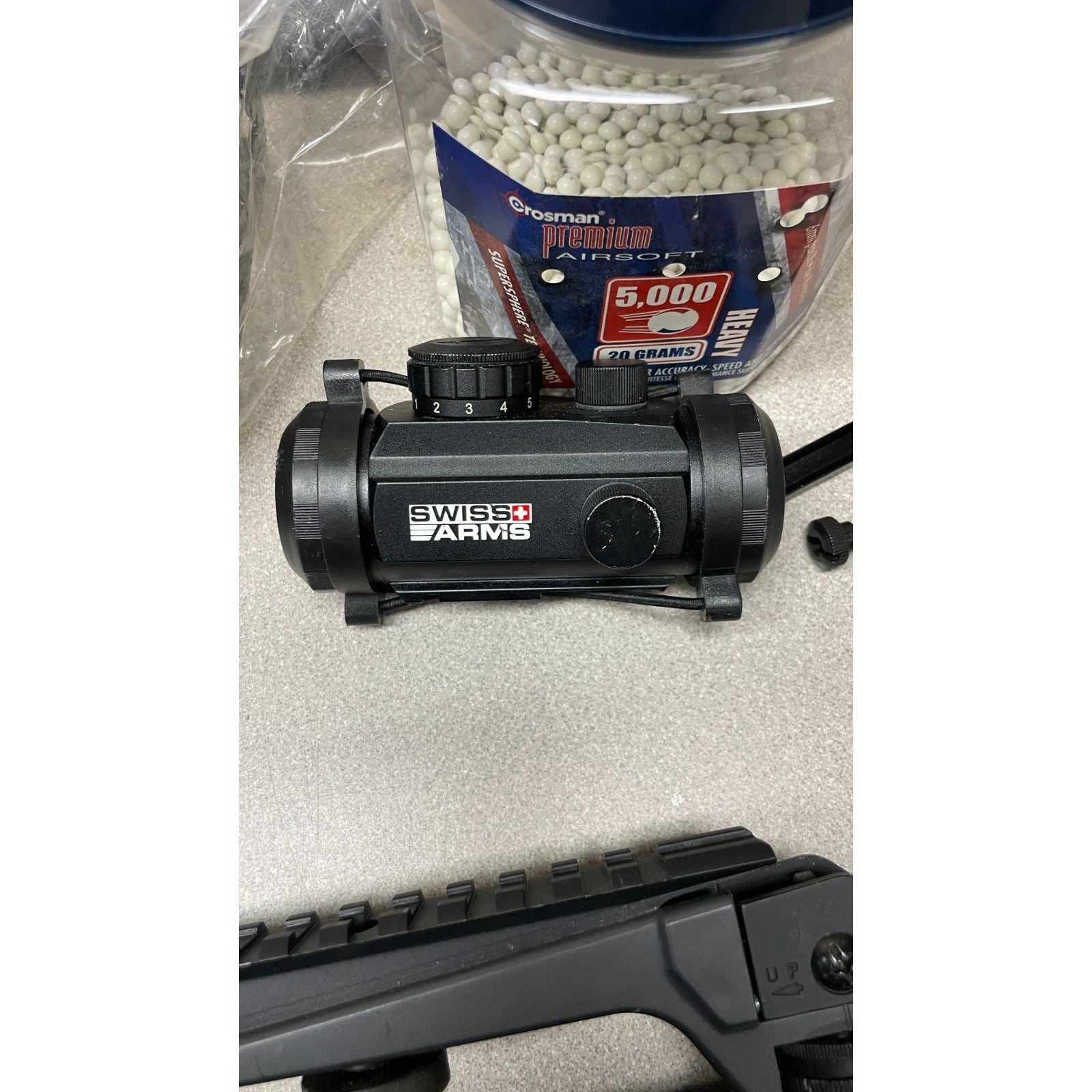 DPMS Panther Arms U050810381 M4 Style Airsoft Gun Lot UNTESTED, Accessories and Bag Included. Swiss Arms Sight, DYE i4 Goggle Lens, Crosman .20 Grams Airsoft closeup of acessories