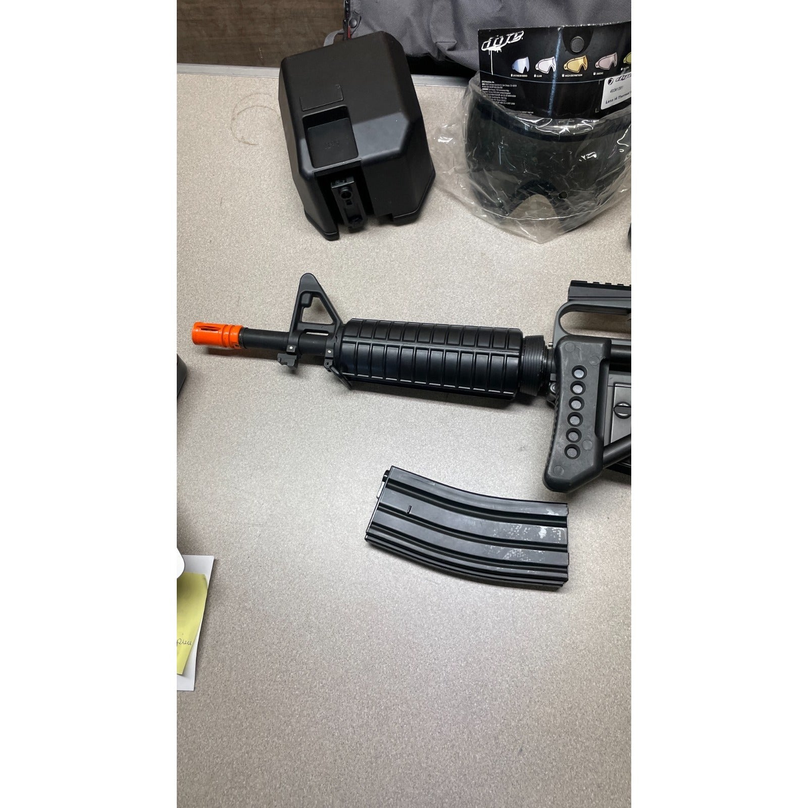 DPMS Panther Arms U050810381 M4 Style Airsoft Gun Lot UNTESTED, Accessories and Bag Included. Swiss Arms Sight, DYE i4 Goggle Lens, Crosman .20 Grams Airsoft closeup of gun nozzle
