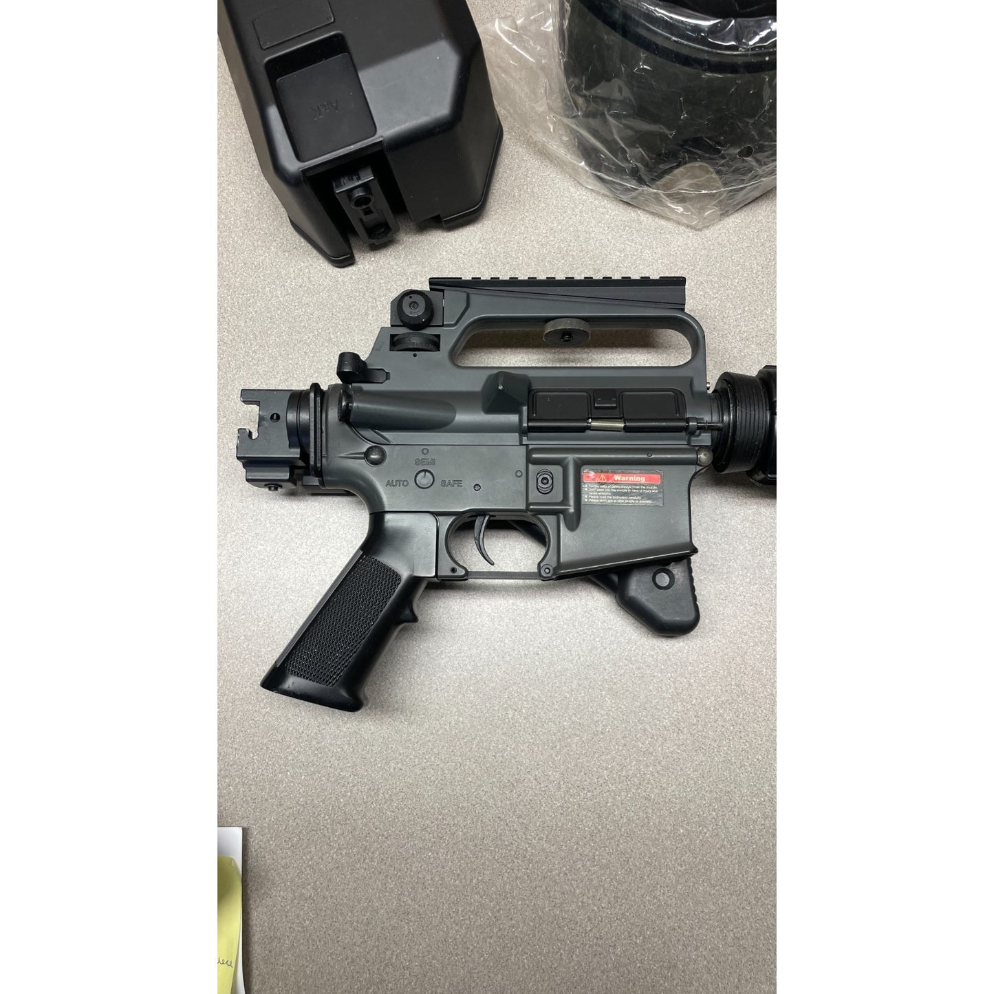 DPMS Panther Arms U050810381 M4 Style Airsoft Gun Lot UNTESTED, Accessories and Bag Included. Swiss Arms Sight, DYE i4 Goggle Lens, Crosman .20 Grams Airsoft closeup of gun
