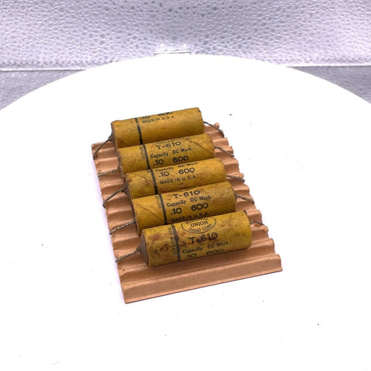 Paper Tubular Condensers National Union CAT. NO: T610 MDF .1 D.C.W.V. 600 (5 Pack) top view of condensers on packaging