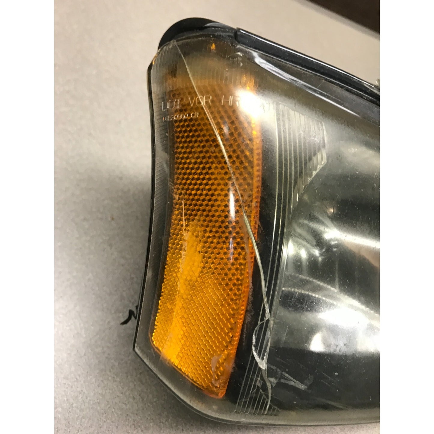 GM 16530938 Right Top Headlight Lens, Fits 2003 Chevy Silverado 2500HD crack closeup